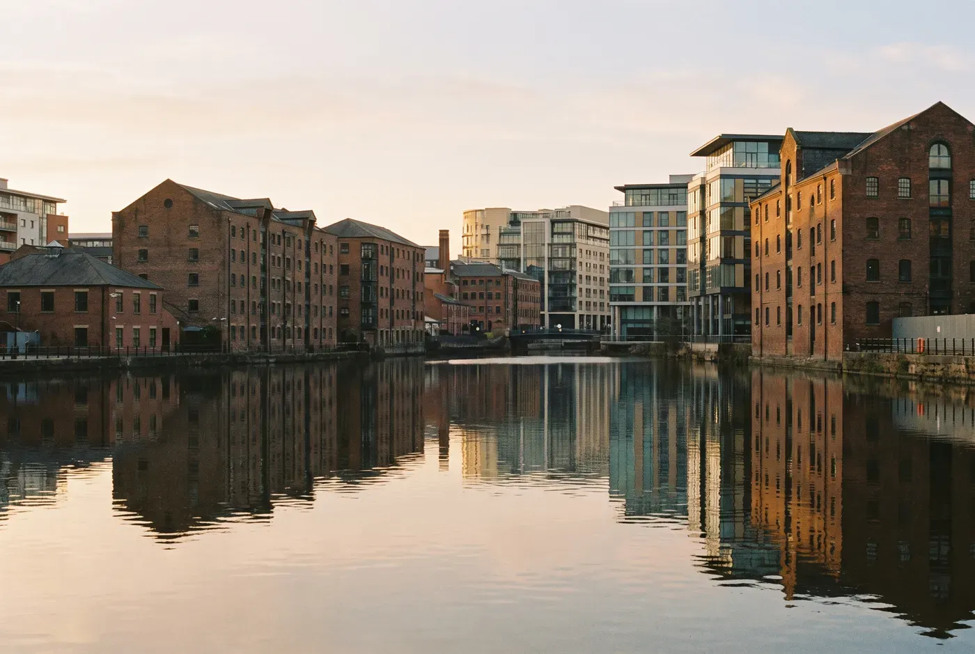 Leeds skyline at golden hour from the River Aire waterfront