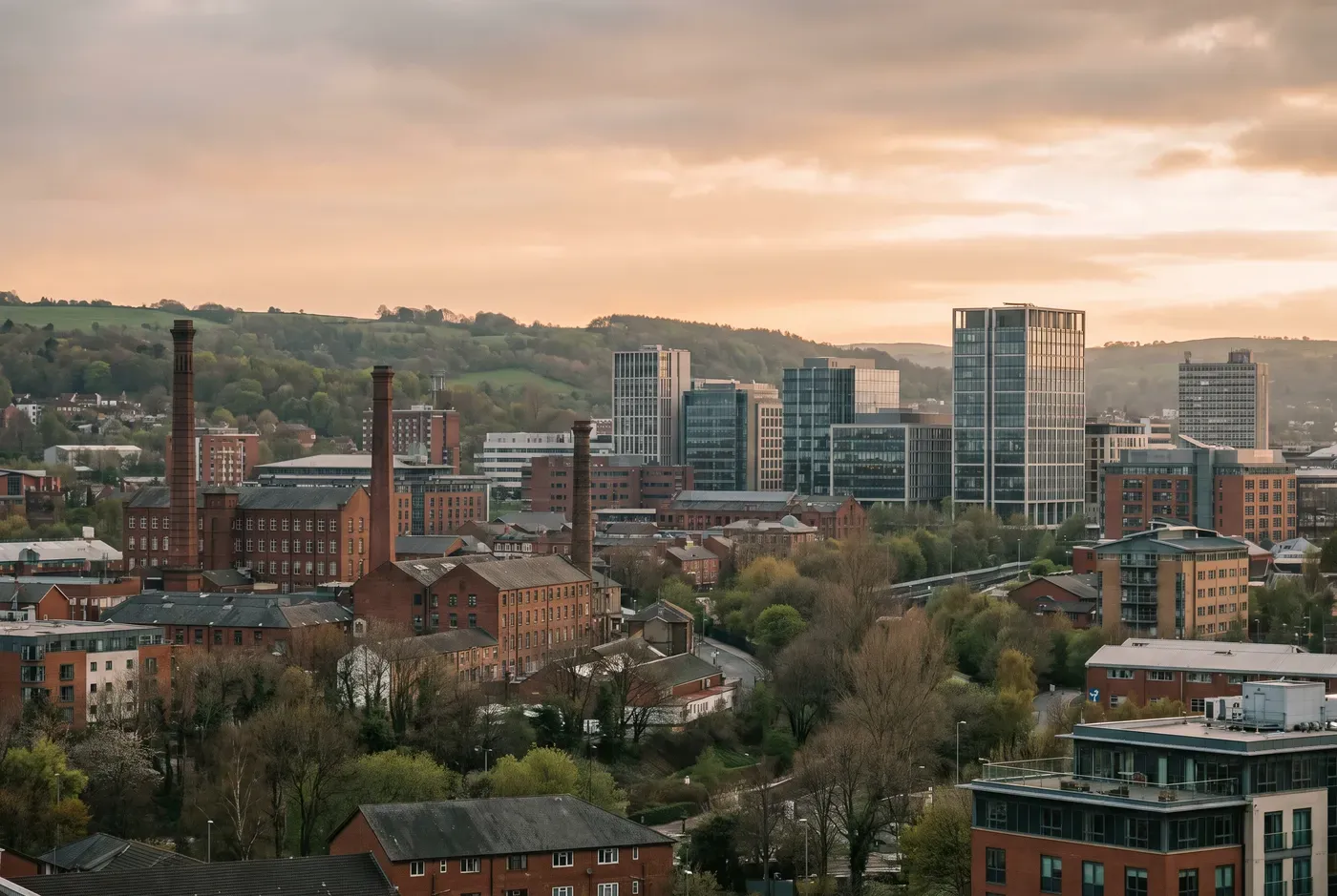 Sheffield city skyline nestled among green hills at golden hour